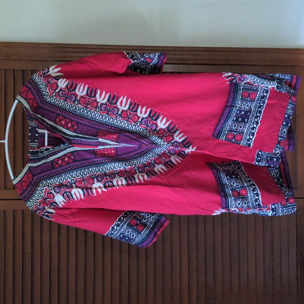 Bohemian top, length is over hips like a tunic. Nice black buttons and pockets.